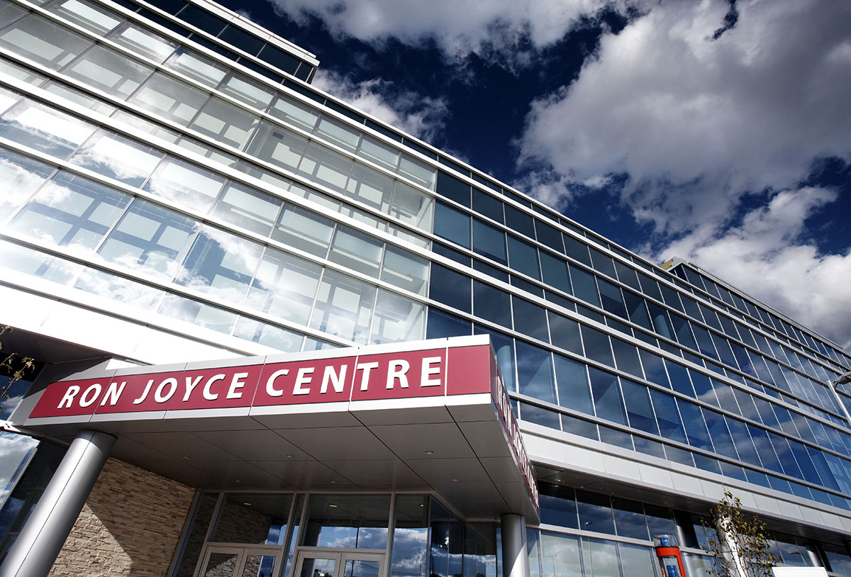 A view of the front door, sign and building that is the Ron Joyce Centre